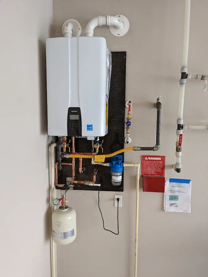 Professional plumber installing copper piping in a Olivehurst home